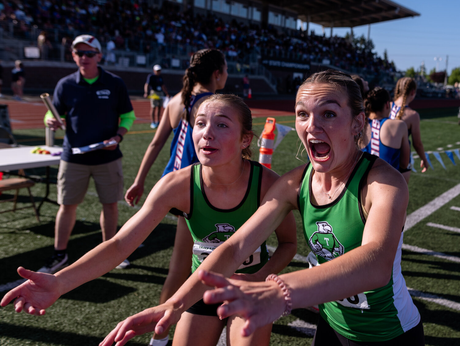Tumwater’s Cassidy Hedin and Reese Heryford scream in excitement about winning the team title following their victory in the 4x400 relay at the WIAA 2A/3A/4A State Track and Field Championships on Saturday, May 27, 2023, at Mount Tahoma High School in Tacoma. (Joshua Hart/For The Chronicle)